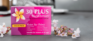 30 Plus NuWoman box on table with flowers